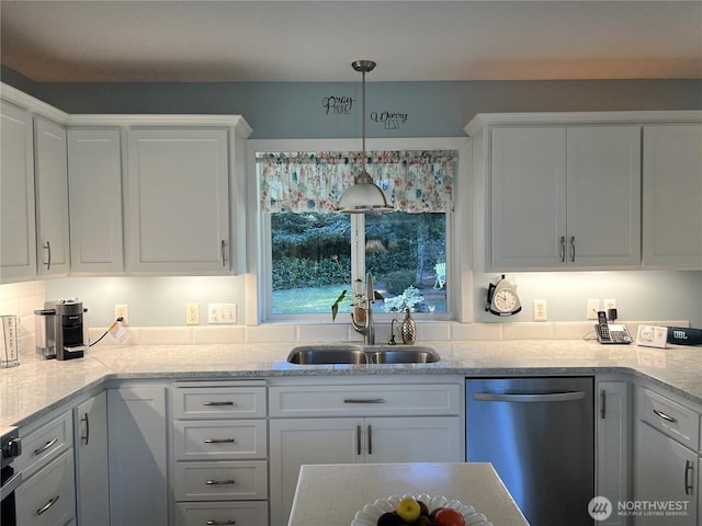 kitchen featuring light stone counters, pendant lighting, white cabinets, and stainless steel dishwasher