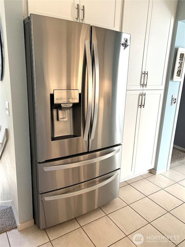 room details featuring stainless steel fridge and baseboards