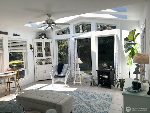 sunroom featuring lofted ceiling with skylight, plenty of natural light, and ceiling fan