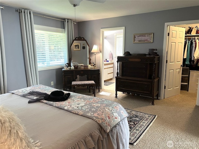 bedroom featuring a walk in closet, a closet, carpet flooring, and ensuite bath