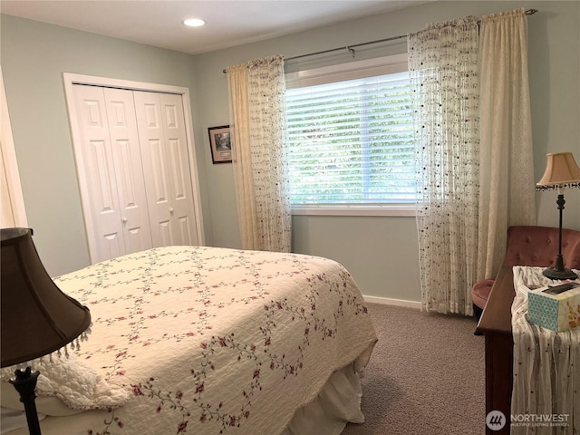 carpeted bedroom featuring a closet, recessed lighting, and baseboards