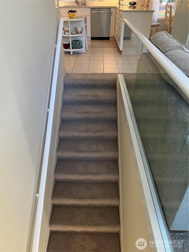 stairs featuring tile patterned flooring