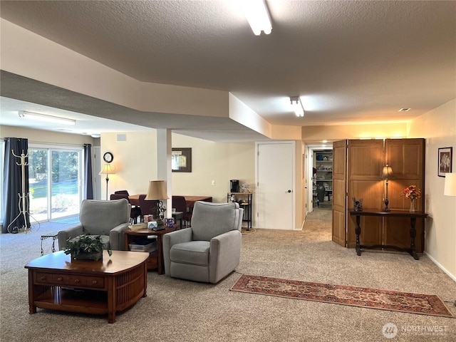 living area with light carpet, visible vents, and a textured ceiling