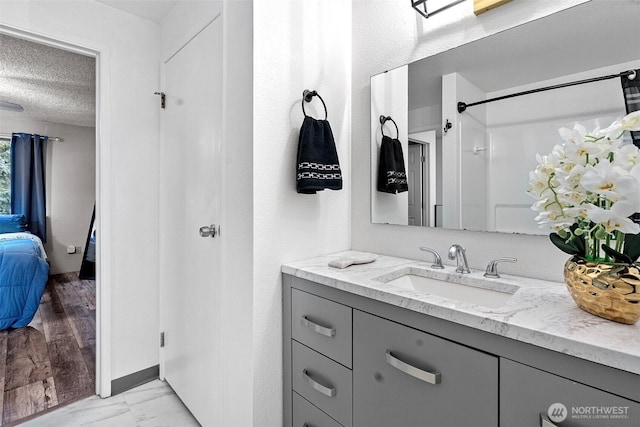 bathroom featuring vanity and a textured ceiling