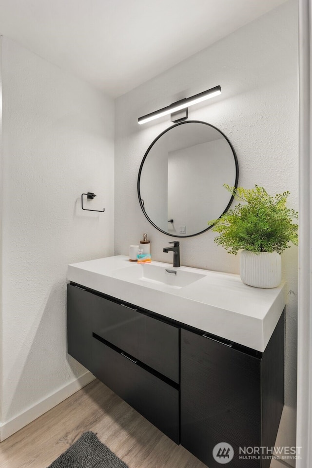 bathroom featuring hardwood / wood-style flooring and vanity