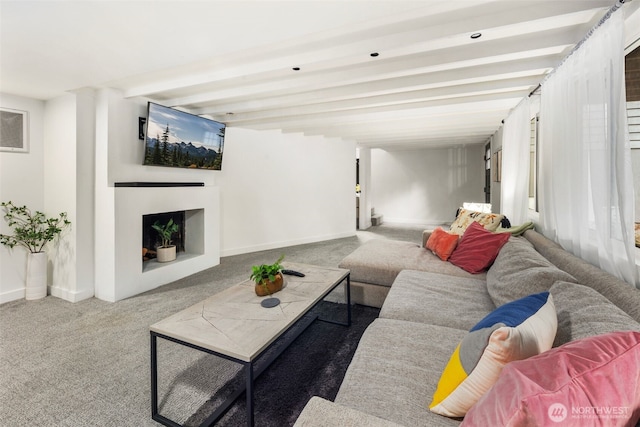 living room with beamed ceiling and carpet