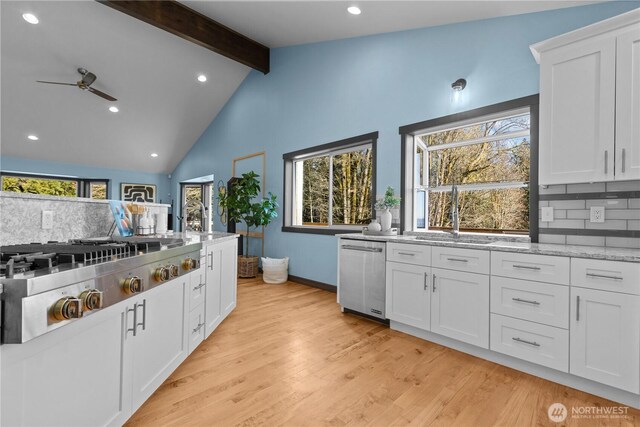 kitchen with white cabinetry, sink, backsplash, and stainless steel appliances