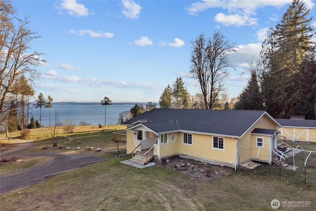 view of front of property with a water view and a front yard