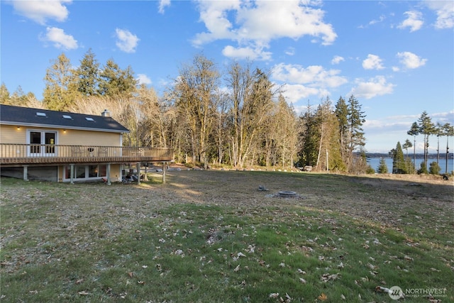 view of yard featuring a deck with water view