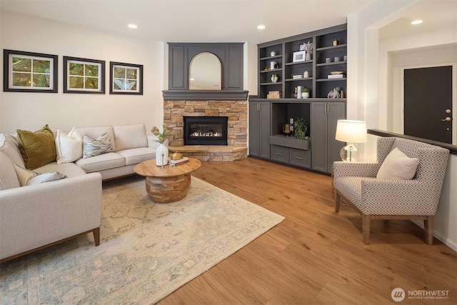 living room featuring a fireplace and light hardwood / wood-style floors