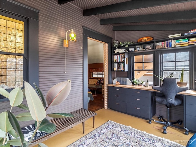 office area featuring beam ceiling and built in desk