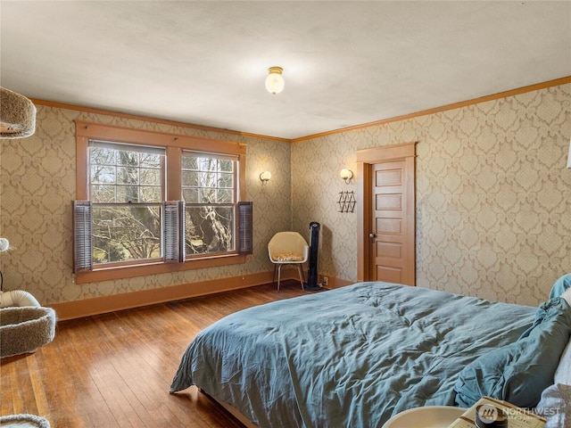 bedroom featuring hardwood / wood-style floors and crown molding