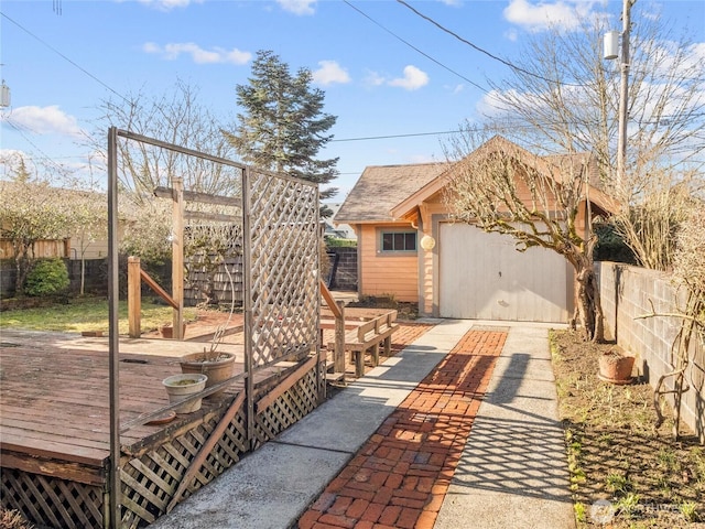 view of front of home featuring a garage, an outbuilding, and a deck