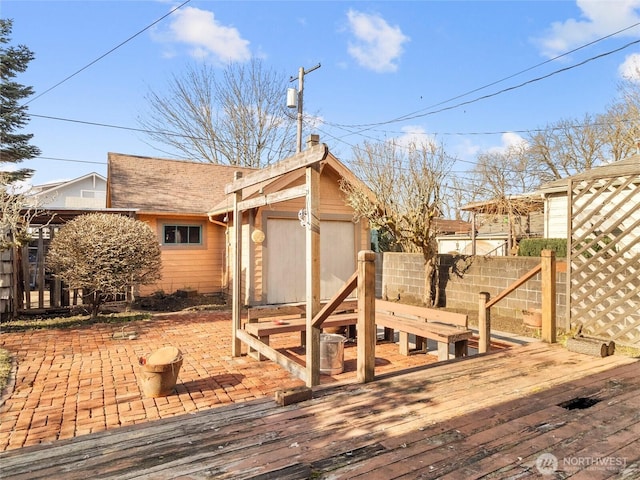 wooden deck with a patio and a storage shed