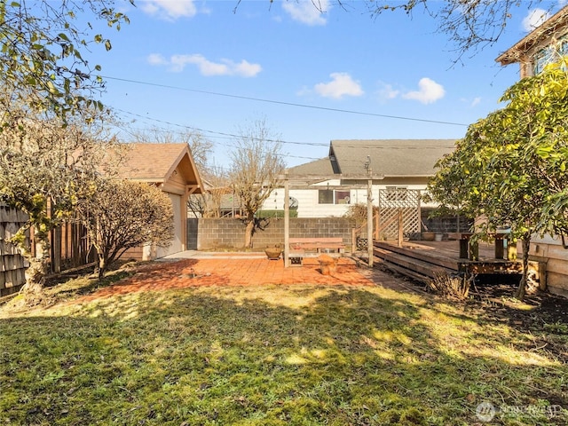 view of yard featuring a patio and a deck