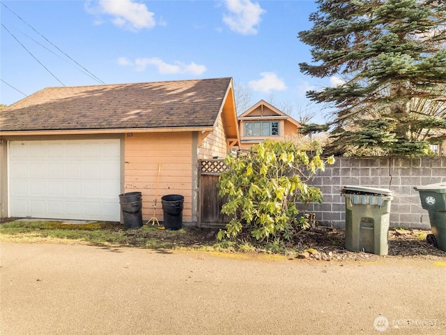 view of side of home with an outbuilding and a garage