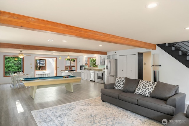 recreation room with billiards, wood-type flooring, beam ceiling, and sink