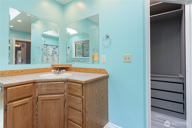 bathroom with vanity and curtained shower