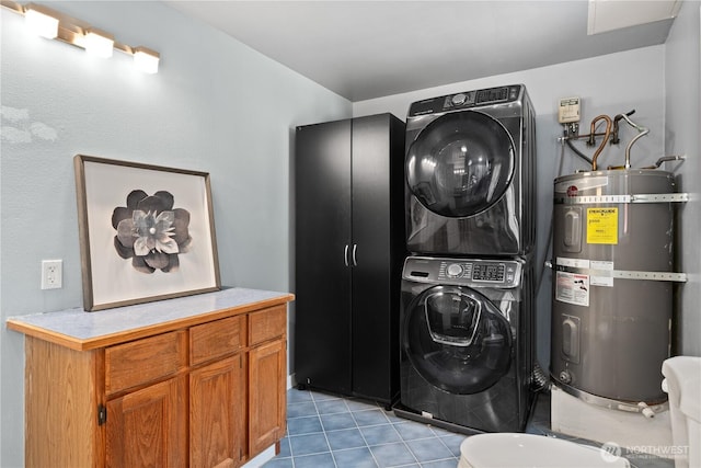 washroom with stacked washer and dryer, water heater, and light tile patterned floors