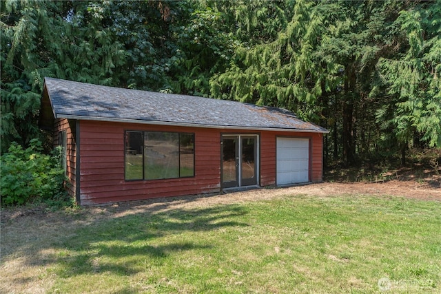 view of outbuilding featuring a garage and a yard