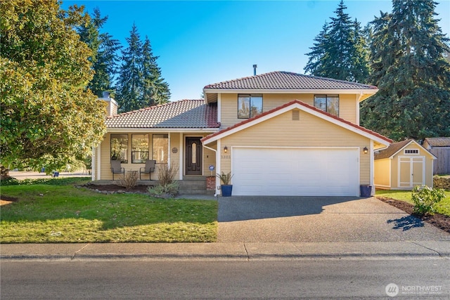 view of front of house featuring a garage, a front yard, covered porch, and a storage shed