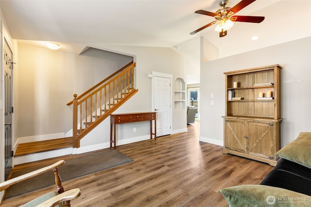 living room featuring wood-type flooring, vaulted ceiling, and ceiling fan