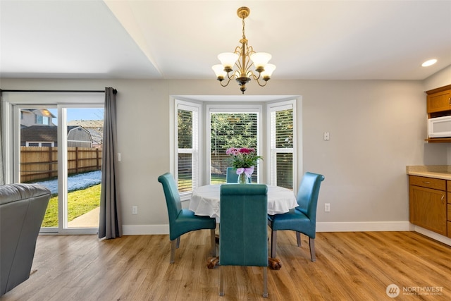 dining room featuring a notable chandelier and light hardwood / wood-style flooring