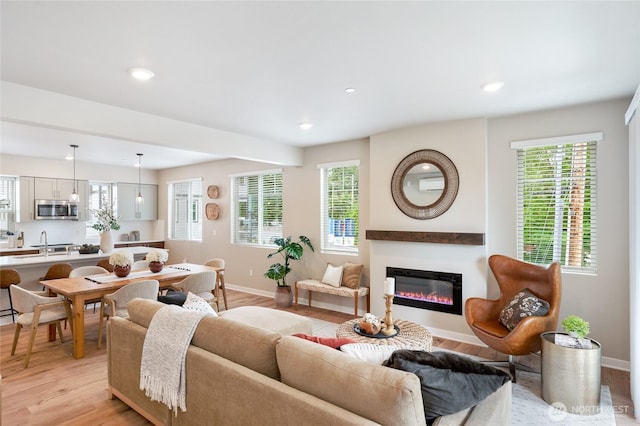 living room featuring sink and light wood-type flooring