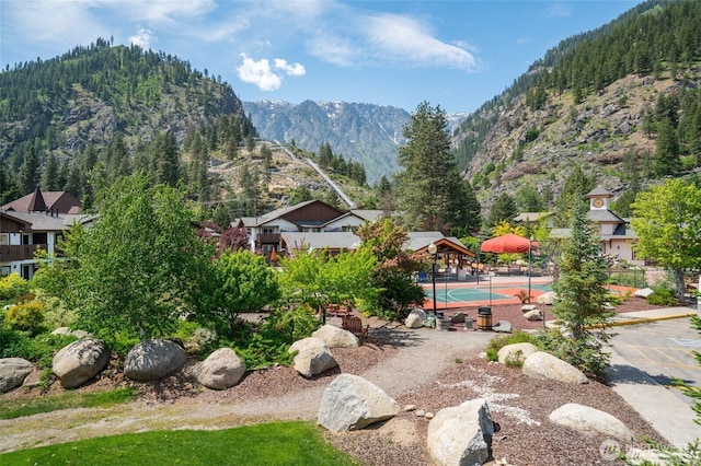 surrounding community featuring a mountain view and tennis court