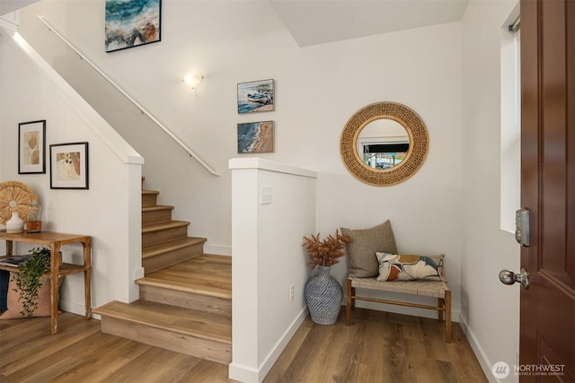 stairs with baseboards and wood finished floors