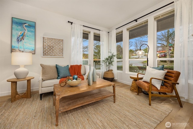 living area featuring light wood-type flooring and baseboards