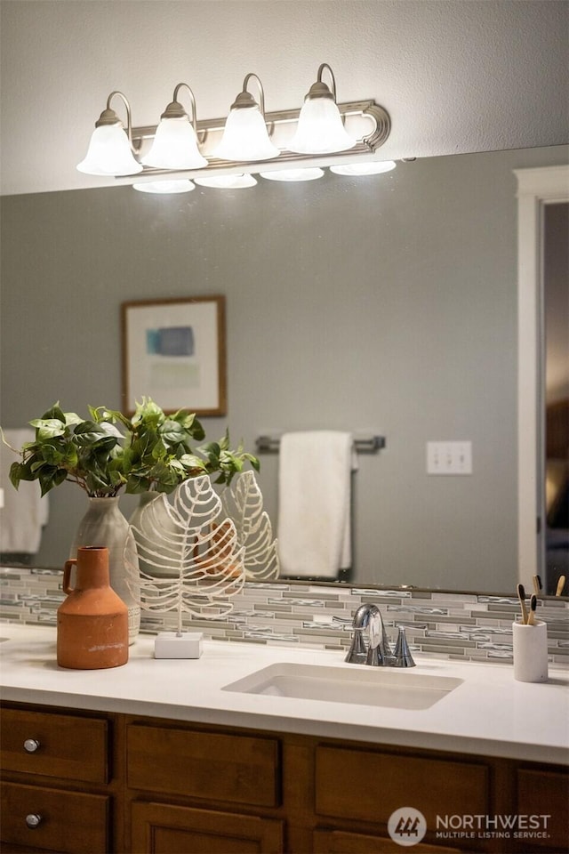 bathroom with decorative backsplash and vanity