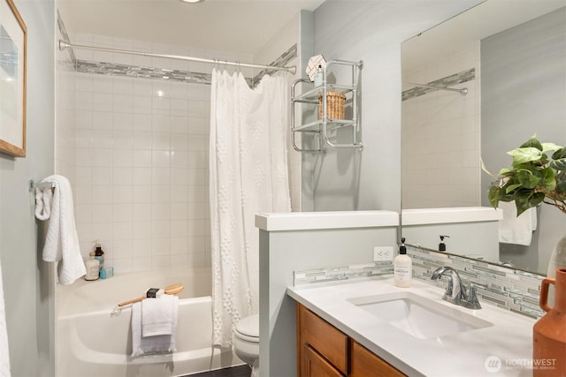 bathroom with backsplash, toilet, shower / bath combo with shower curtain, and vanity