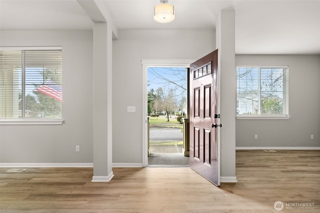 foyer entrance with light hardwood / wood-style flooring