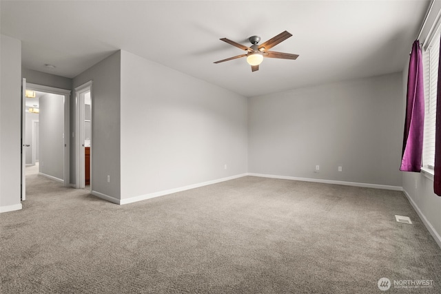 carpeted spare room with ceiling fan