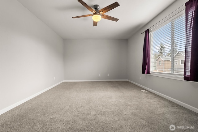 unfurnished room with ceiling fan and carpet floors