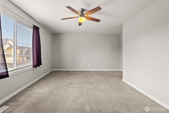 carpeted spare room with ceiling fan