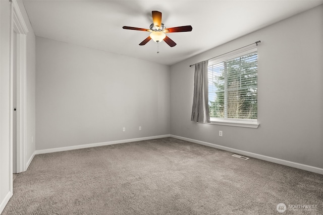 empty room featuring carpet flooring and ceiling fan