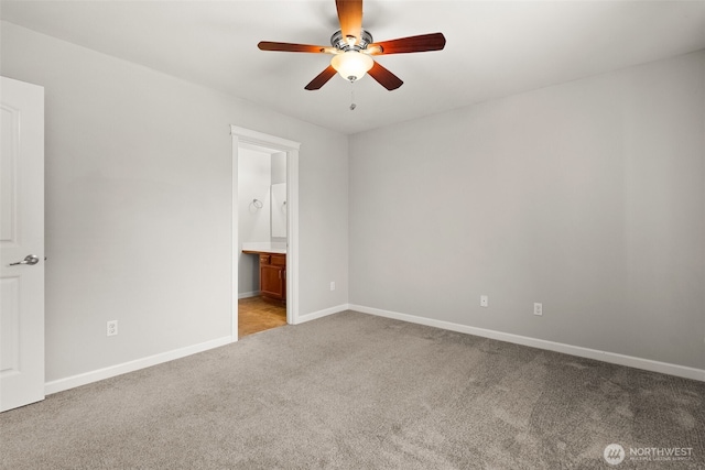 unfurnished bedroom with ensuite bathroom, ceiling fan, and light colored carpet