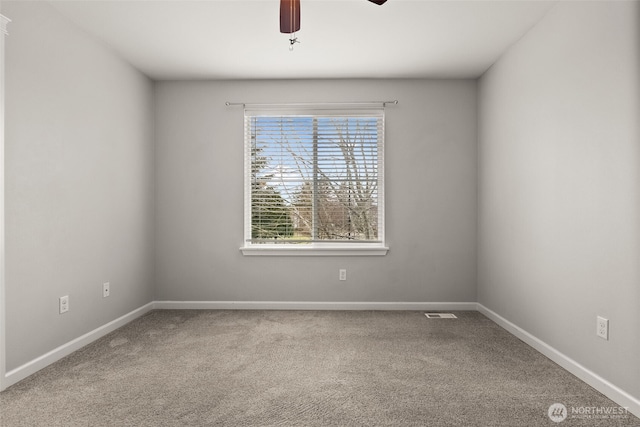 unfurnished room with ceiling fan and carpet flooring