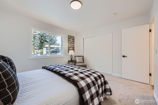 bedroom featuring a closet and light carpet