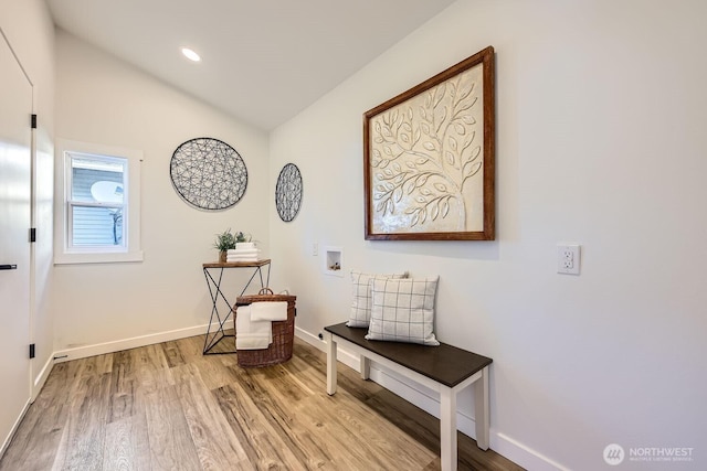 interior space featuring hardwood / wood-style floors and vaulted ceiling