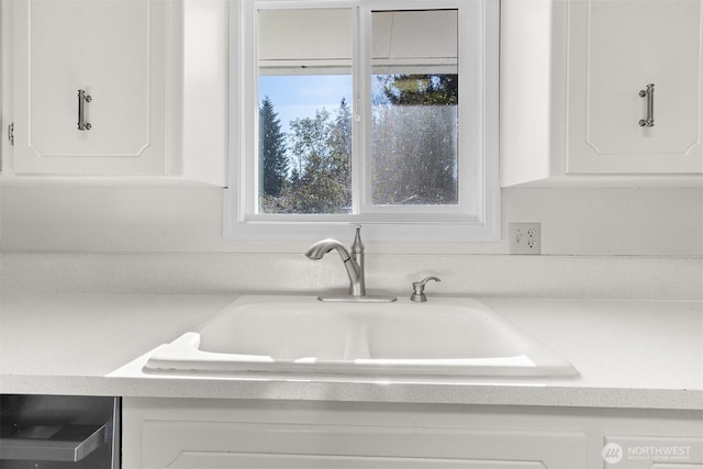 interior space featuring sink and white cabinets