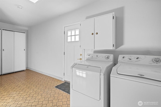 laundry room with cabinets and washer and dryer