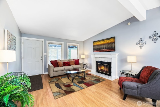 living room with a fireplace, wood-type flooring, and lofted ceiling with beams