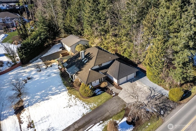 drone / aerial view featuring a wooded view