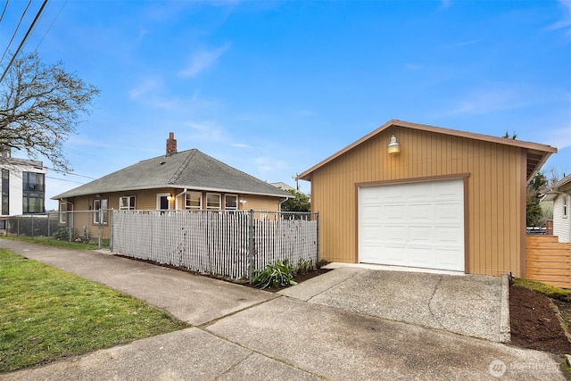 view of front of property featuring an outbuilding and a garage