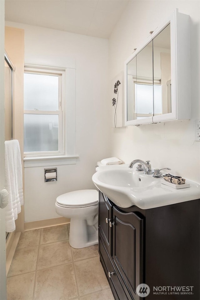 bathroom featuring tile patterned floors, toilet, and vanity