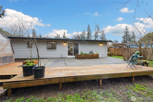 exterior space with a deck and fence