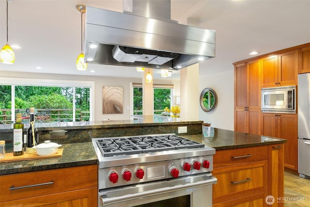 kitchen with dark stone counters, stainless steel appliances, extractor fan, and brown cabinets